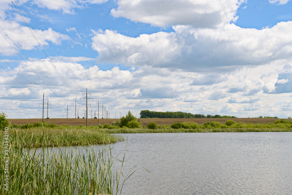 Summer landscape with a power line across the lake Summer landscape with a power line across the lake