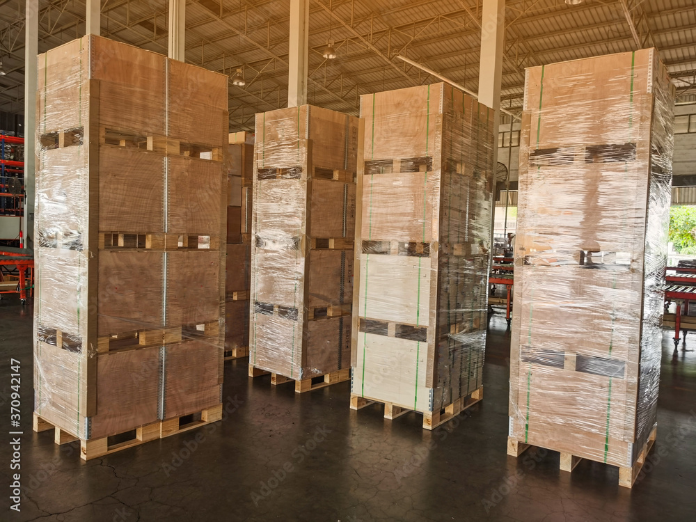 Shipment cartons box on pallets and wooden case on forklift in interior warehouse cargo for export and sorting goods in freight logistics and transportation industrial Shipment cartons box on pallets and wooden case on forklift in interior warehouse cargo for export and sorting goods in freight logistics and transportation industrial