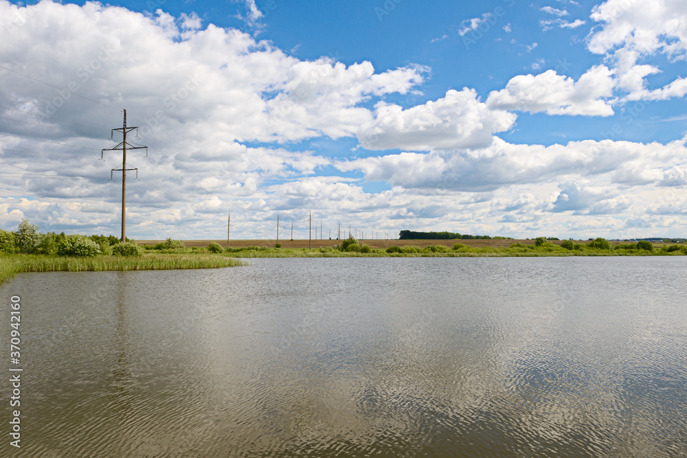 Summer landscape with a power line across the lake Summer landscape with a power line across the lake
