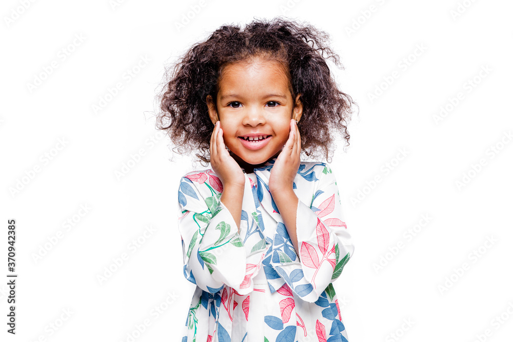 Little pretty fashionable african american girl in blue dress with surprised facial expression on white background Little pretty fashionable african american girl in blue dress with surprised facial expression on white background