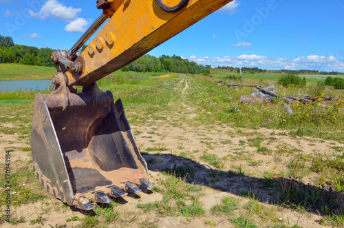 agrimotor on green field and blue sky