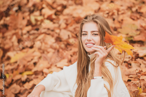 Autumn trend. Beautiful woman fashion model having fun in fall park outdoors