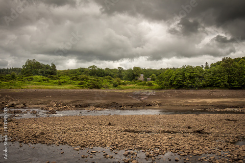 The original Water of Ken river bed exposed and the Earlstoun Castle ruin