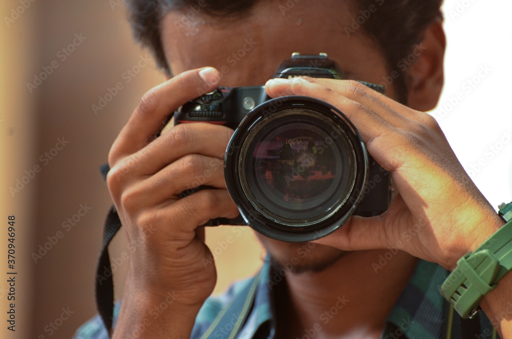 Photographer with camera pointed at camera Photographer with camera pointed at camera