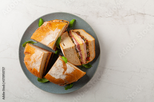 Muffuletta. Sandwich with cheese, ham and olive paste. A traditional recipe in New Orleans. photo