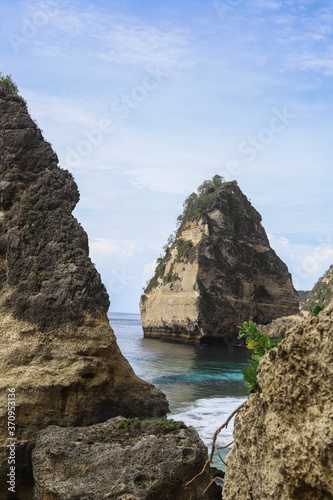 The beautiful Diamond Beach on Nusa Penida Island, Bali, Indonesia. Amazing view, white sand beach with rocky mountains and azure lagoon with clear water of Indian Ocean 