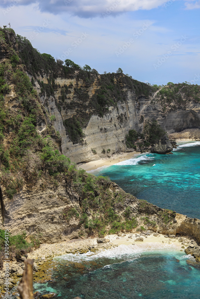 The beautiful Diamond Beach on Nusa Penida Island, Bali, Indonesia. Amazing  view, white sand beach with rocky mountains and azure lagoon with clear water of Indian Ocean 