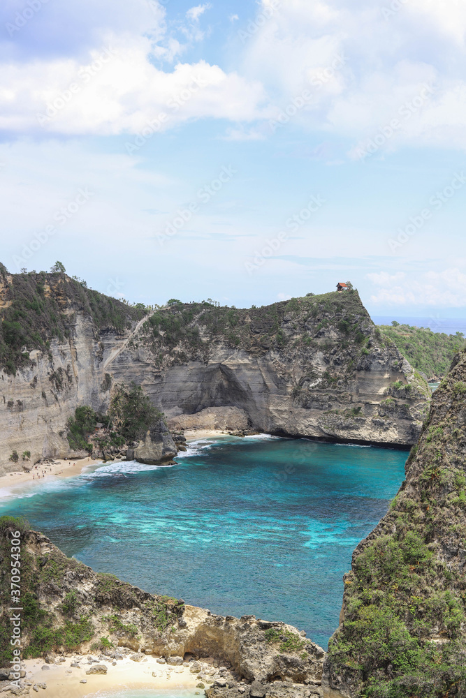 The beautiful Diamond Beach on Nusa Penida Island, Bali, Indonesia. Amazing  view, white sand beach with rocky mountains and azure lagoon with clear water of Indian Ocean 