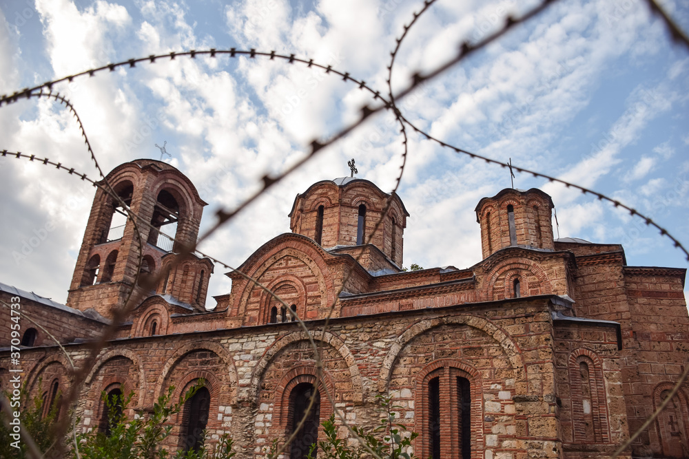 image of orthodox Christian church protected by barbed wire in Kosovo