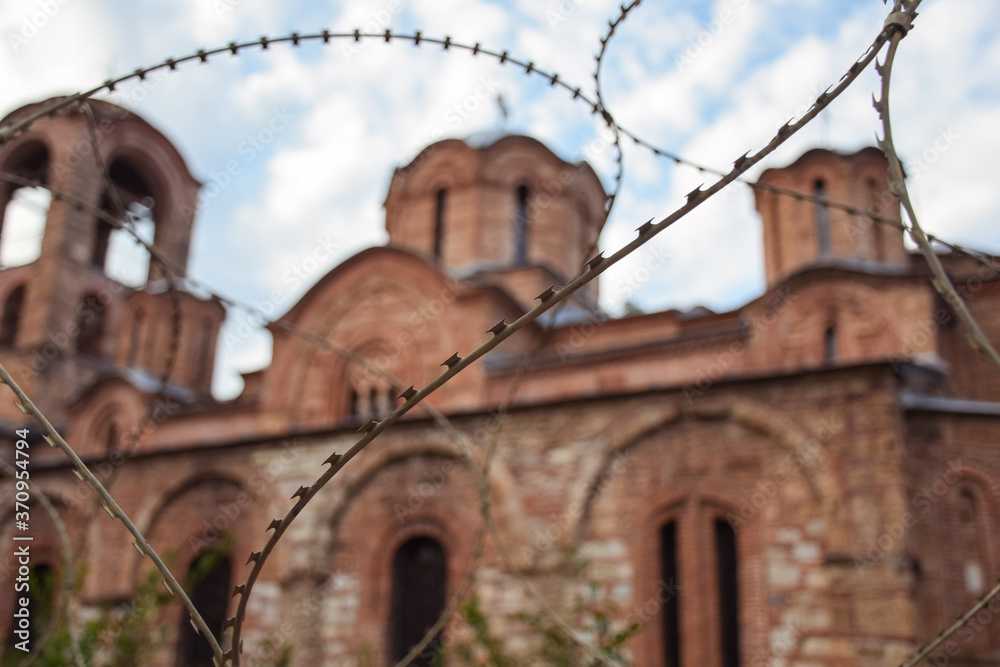 image of orthodox Christian church protected by barbed wire in Kosovo
