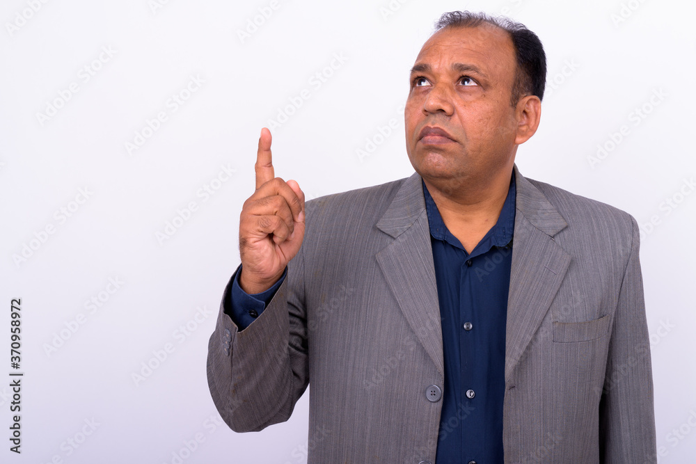 Portrait of mature overweight Indian businessman in suit Portrait of mature overweight Indian businessman in suit