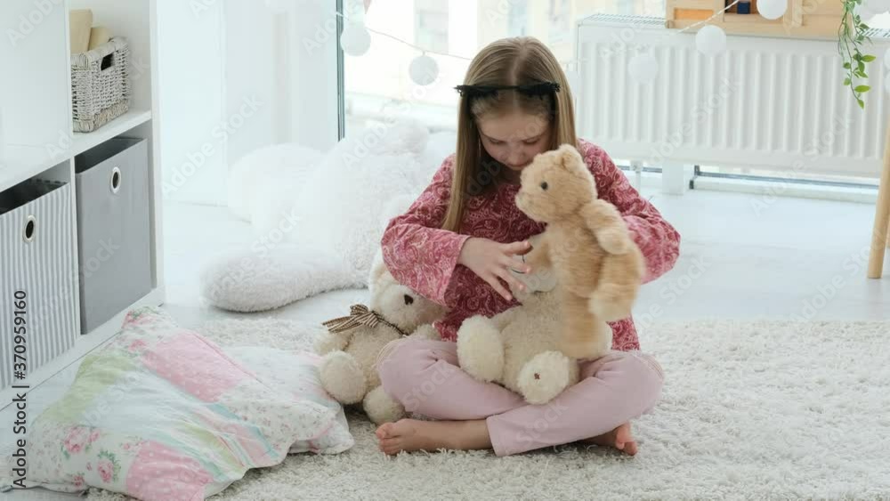 Little girl playing with teddy bears in a kids room Little girl playing with teddy bears in a kids room