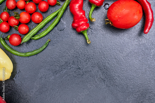 red vegetables on a black table  mockup  copy space flatlay