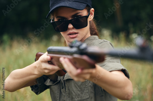 Military woman Hunting in dark glasses green overalls 
