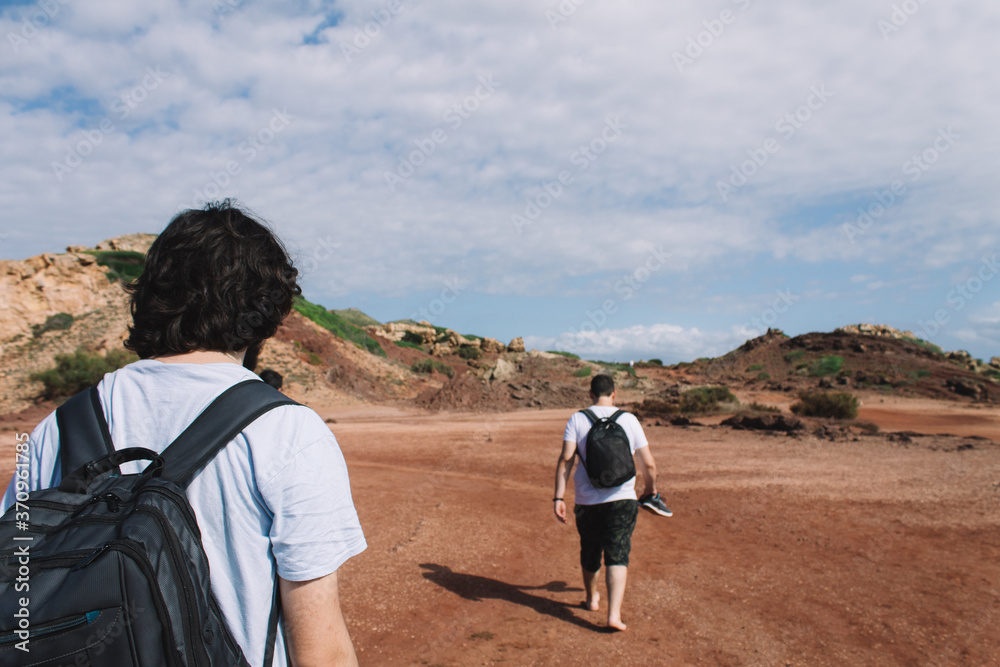 Group of young people walk to the beach in the Mediterranean. Concept of going to the beach