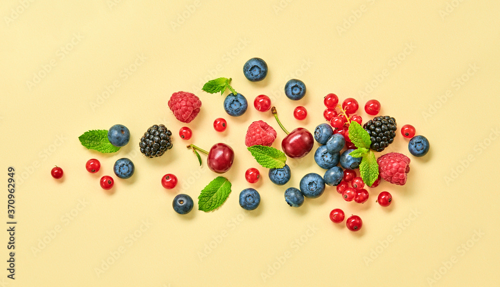 Blueberry, raspberry, blackberry, redcurrant, cherry. Fresh blueberry, berries mix closeup. Red raspberry, mint creative composition on yellow. Colorful trendy concept, top view. Blueberry, raspberry, blackberry, redcurrant, cherry. Fresh blueberry, berries mix closeup. Red raspberry, mint creative composition on yellow. Colorful trendy concept, top view.