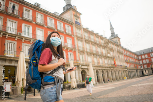 new normal backpacker girl in holidays travel - young happy and attractive Asian Korean woman in face mask enjoying city tour cheerful after covid19 lockdown