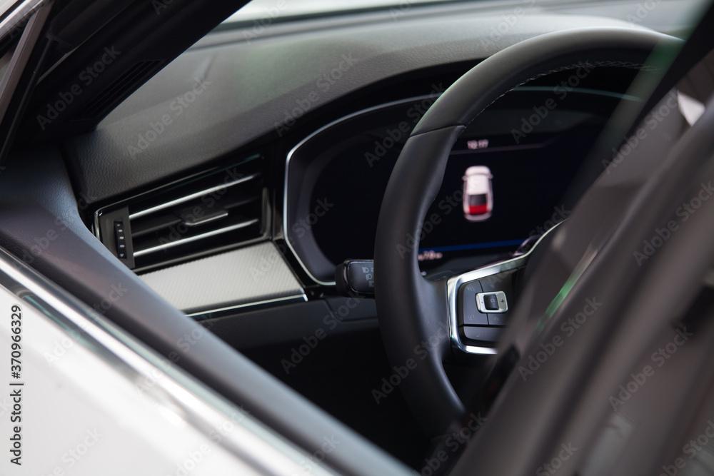 view of the steering wheel and car dashboard through the window