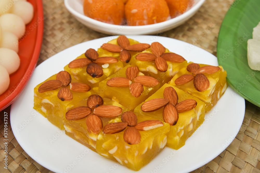 Burfi Delhi sweets for Diwali Indian mithai. Indian sweet food or diwali sweets Mithai Halwa, Milk Peda, Laddu or Ladoo, Rasgulla, Rasagulla for celebration in Delhi, India. Burfi Delhi sweets for Diwali Indian mithai. Indian sweet food or diwali sweets Mithai Halwa, Milk Peda, Laddu or Ladoo, Rasgulla, Rasagulla for celebration in Delhi, India.
