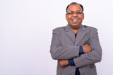 Portrait of happy mature overweight Indian businessman in suit