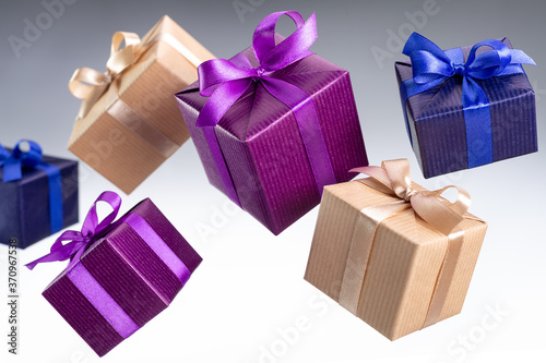 Gifts in boxes, in bright festive packaging for various events. Gray background, studio shot.