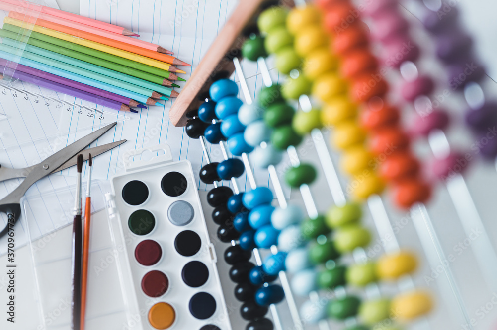 Back to school. Items for the school on a blue wooden table. School supplies on white board background. Back to school concept. Back to school. Items for the school on a blue wooden table. School supplies on white board background. Back to school concept.