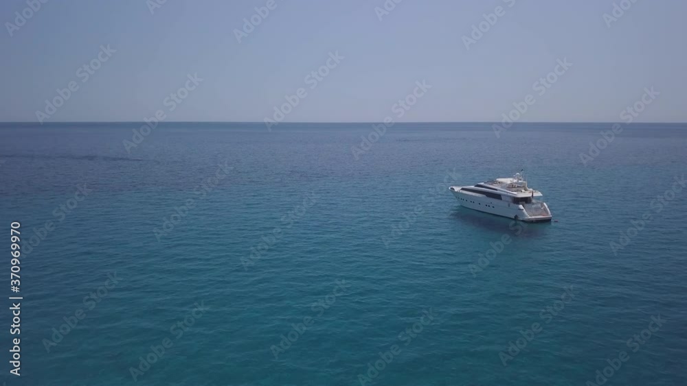 Luxury Yacht Aerial View in Sardinia sea water with clear blue sky in a sunny day during summer season Luxury Yacht Aerial View in Sardinia sea water with clear blue sky in a sunny day during summer season