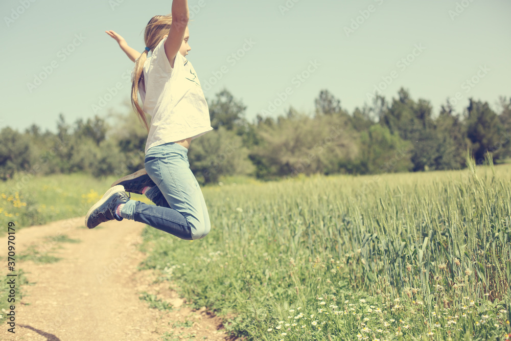 9 year old girl walking in the flowers field 9 year old girl walking in the flowers field