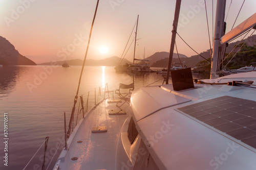 Sailing and yachting vacation concept: morning on sail boat, sea and boats view in the sea, soft morning rays