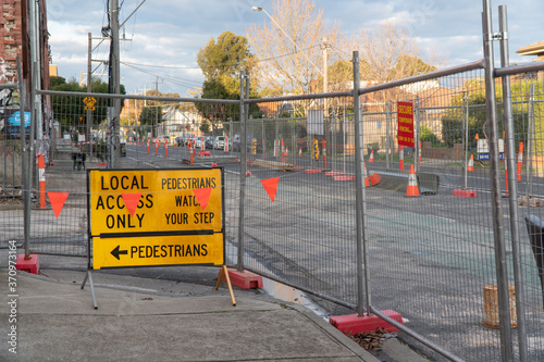 traffic management and road works signs with temporary fencing on a street in Melbourne