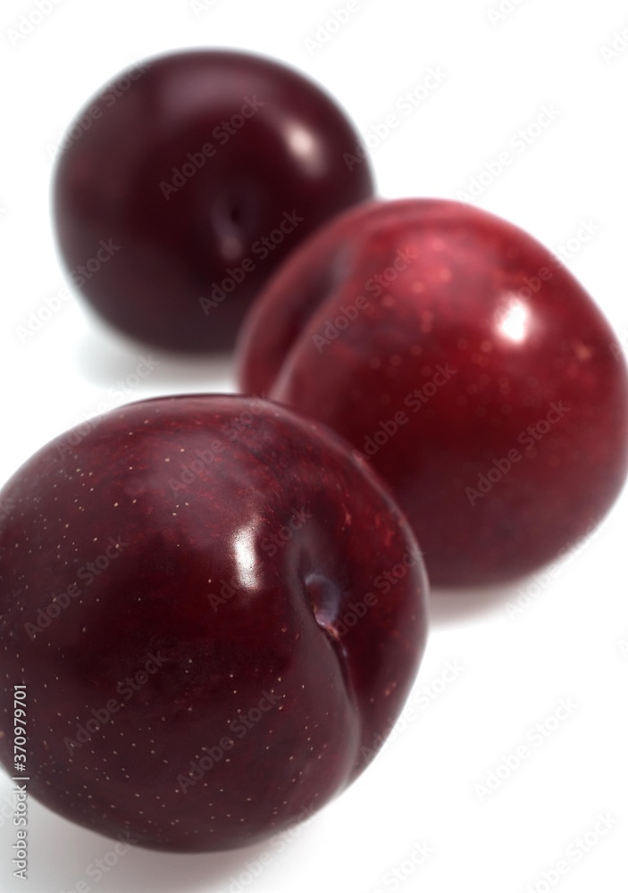 Red Plums, Fruits against White Background Red Plums, Fruits against White Background