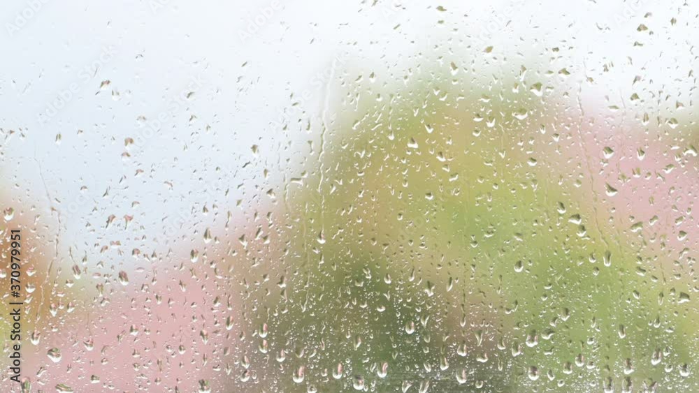 Close-up of Rain Drops On The Windows Glass. Rain drops strike a window pane. Close-up of Rain Drops On The Windows Glass. Rain drops strike a window pane.