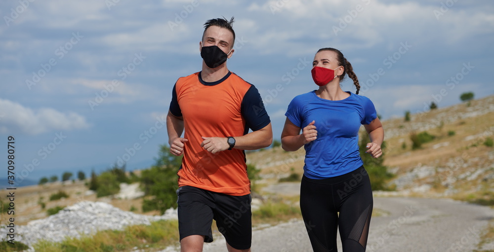 couple running in nature wearing mask couple running in nature wearing mask