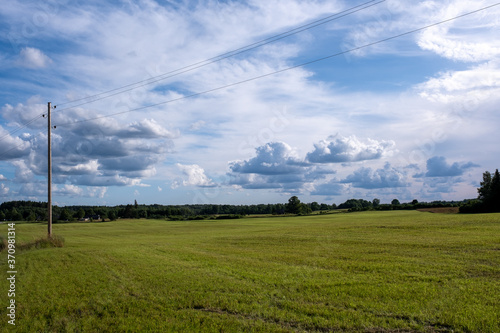 a rural landscape with cut fields and a dramatically brilliant blue sky