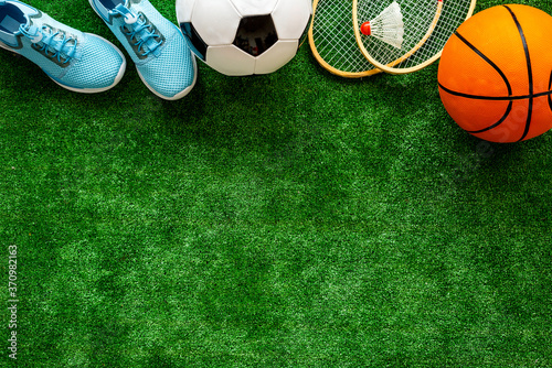 Flat lay of sport balls - football, basketball on grass. Top view copy space © 9dreamstudio