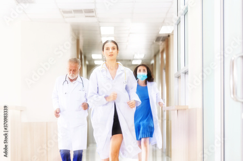 Motion blur background group of doctor and medical team running rushing to the rescue center hallway in hospital. emergency to saving patient life. health care concept 
