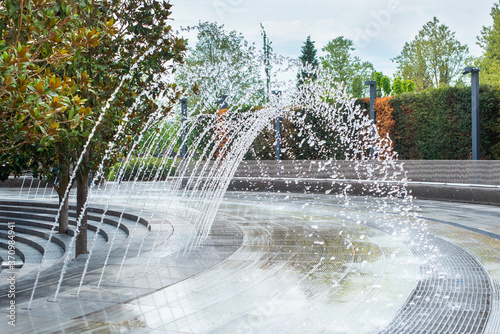 beautiful fountain in Krasnodar. you can pass under the arc of water. a splash cascade forms a passage. people walk