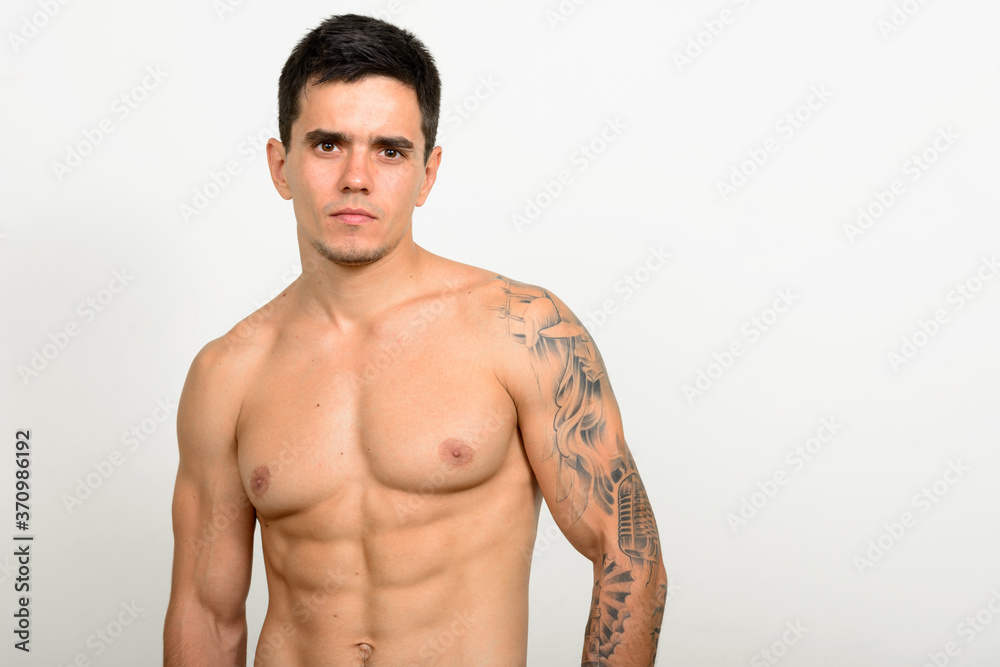 Fototapeta premium Portrait of handsome muscular shirtless man against white background