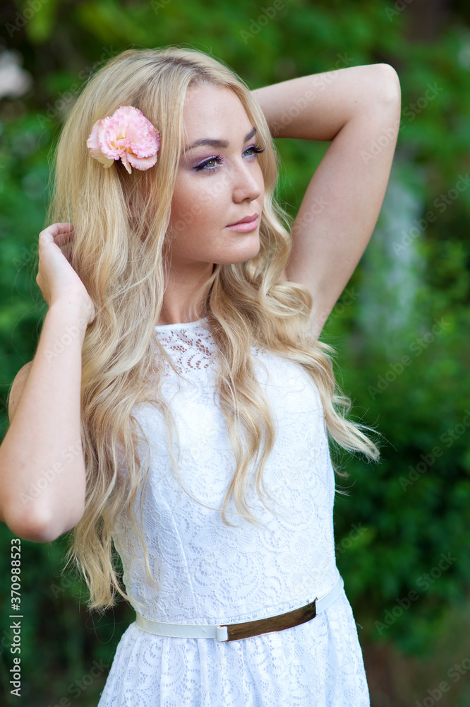 Naklejka premium Beautiful young woman with flower. Blonde. Hair care. Summer