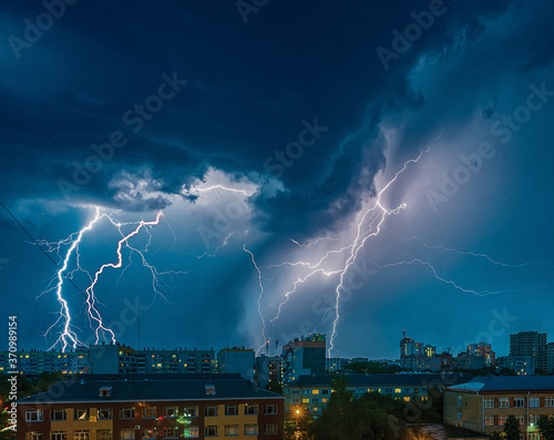 a strong thunderstorm with ligtnings over the city