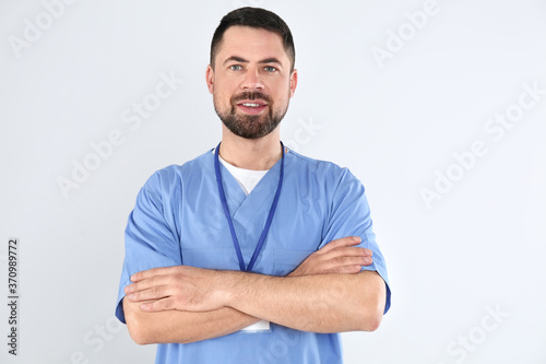 Portrait of mature doctor on white background