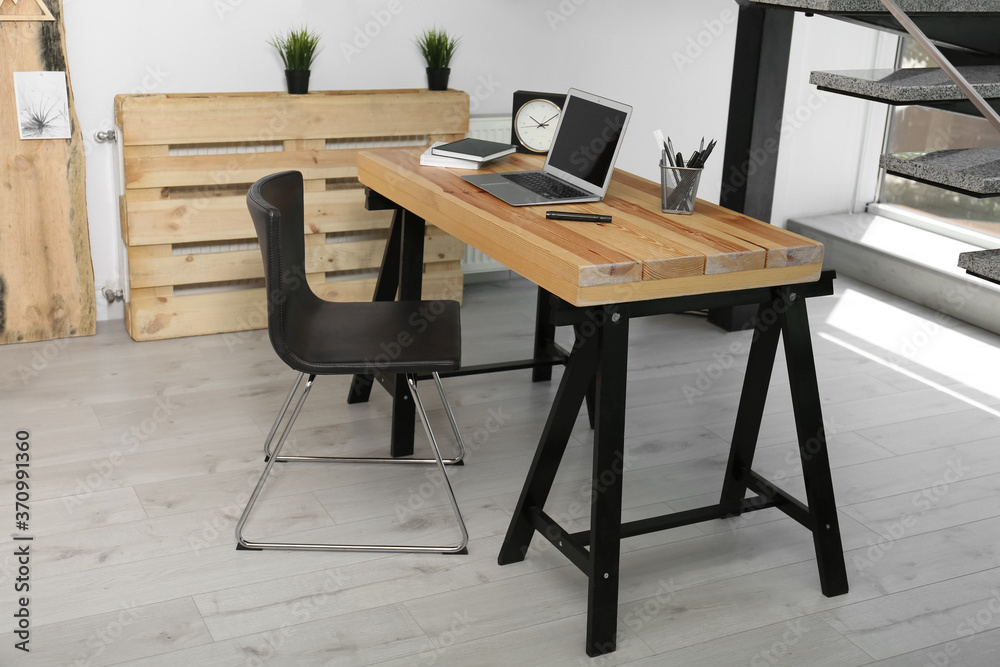 Comfortable workplace with office chair and wooden table Comfortable workplace with office chair and wooden table
