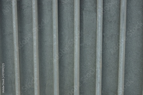 gray metal texture of iron wall with a row of rods