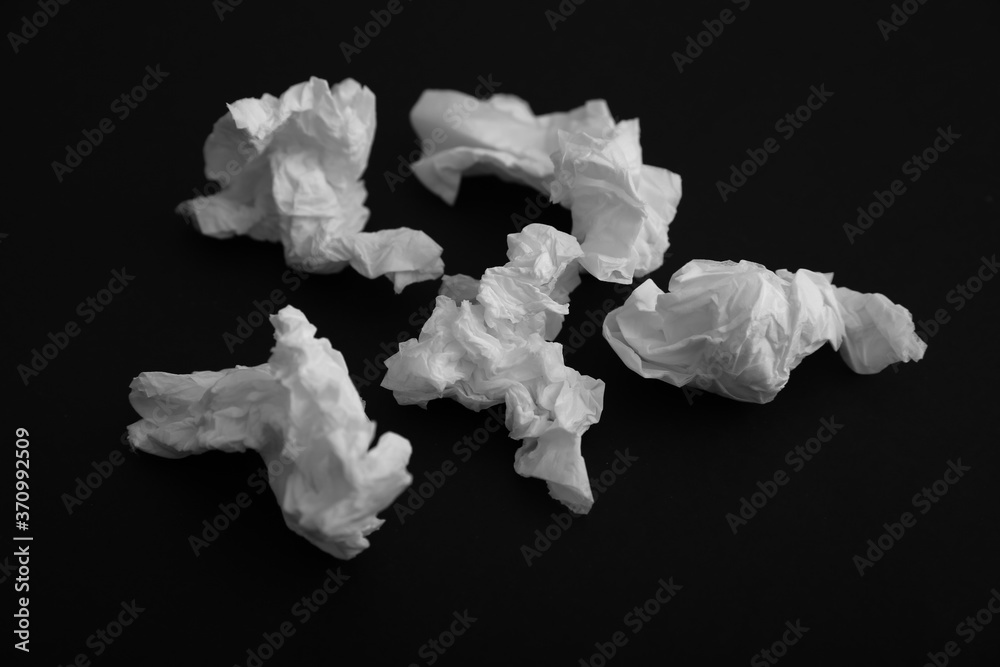 Used white paper tissues on black background