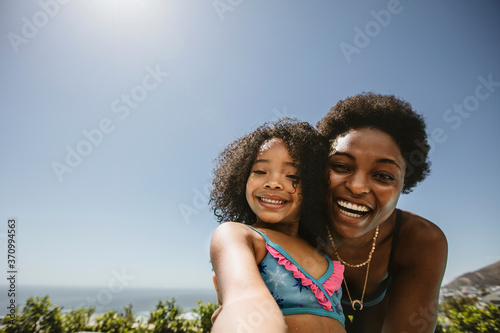 Mother and daughter taking a selfie outdoors