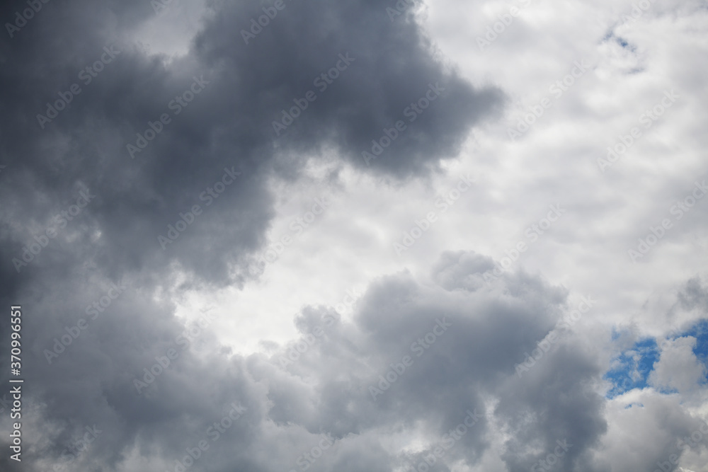 Disturbing gray clouds, covering the blue sky