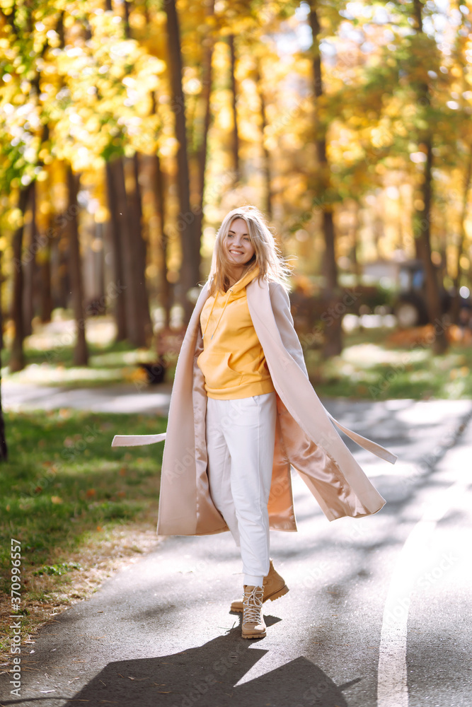 Stylish woman enjoying autumn weather in the park. Beautiful Woman having fun in the forest. Relaxation, enjoying, solitude with nature. Stylish woman enjoying autumn weather in the park. Beautiful Woman having fun in the forest. Relaxation, enjoying, solitude with nature.