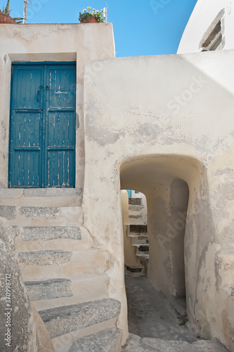 Village street with staircases and entrance doors in Santorini island © havoc