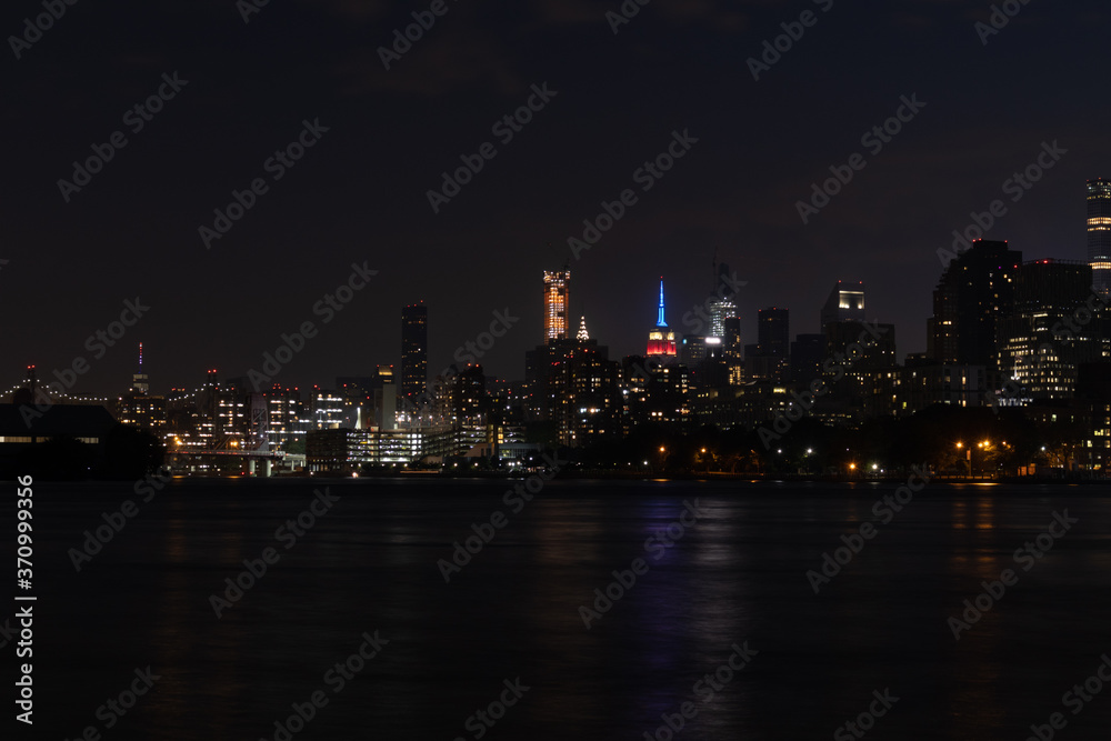 Dark Nighttime Roosevelt Island and Manhattan Skyline along the East River in New York City