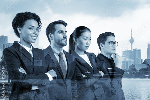 Four successful business consultants standing in a row in suits and ready to tackle with customer problem. Kuala Lumpur cityscape. KL skyscrapers. Double exposure. photo